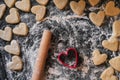 shortbread cookie cutter and rolling pin on a floured table