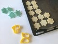 Shortbread cookie with sesame on a baking sheet. Before shipment to the oven. Nearby lie molds for shaping the dough.