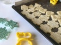 Shortbread cookie with sesame on a baking sheet. Before shipment to the oven. Nearby lie molds for shaping the dough.