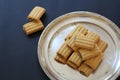 Shortbread cookies with chocolate filling, small cookies on a silver tray, a mound of fresh cookies, an addition to tea or coffee