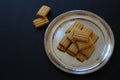 Shortbread cookies with chocolate filling, small cookies on a silver tray, a mound of fresh cookies, an addition to tea or coffee