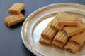 Shortbread cookies with chocolate filling, small cookies on a silver tray, a mound of fresh cookies, an addition to tea or coffee