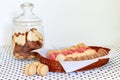 Shortbread cookies in a glass bin and French macaroons in a basket Royalty Free Stock Photo