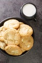 Shortbread cookies with macadamia nuts and white chocolate with cup of milk. Vertical top view Royalty Free Stock Photo