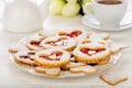 Shortbread cookies in the shape of heart with strawberry jam on wooden table. Royalty Free Stock Photo