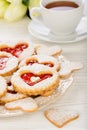 Shortbread cookies in the shape of heart with strawberry jam on wooden table. Royalty Free Stock Photo