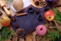 Shortbread dough, pears, spices and baking molds surrounding the black board