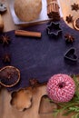 Shortbread dough, pears, spices and baking molds surrounding the black board