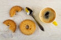 Shortbread rings with sesame, spoon, broken cookie, cup with espresso on table. Top view Royalty Free Stock Photo