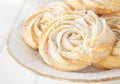 Shortbread whipped nuts cookies on white plate. White wooden background. Copy space. Close up
