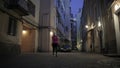 Shortcut blondie woman goes out from inner yand to the street at dark night