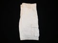 Shorts beige, lateral side, on black background