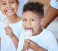 Sweet treat for sweet kids. Shot of an adorable little boy and girl eating an ice-cream cone while sitting outside. Royalty Free Stock Photo