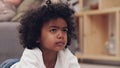 When can I get a chance to choose a movie. Shot of an adorable little boy lying down on a carpet and watching tv at home Royalty Free Stock Photo