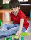 Little boys simply love trains, planes, trucks and cars. Shot of an adorable little boy playing with toys at home. Royalty Free Stock Photo