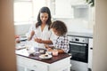 Always worth the mess it leaves. Shot of an adorable little girl baking with her mom at home. Royalty Free Stock Photo