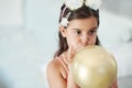 I want to see how big it gets. Shot of an adorable little girl blowing up a balloon at her birthday party. Royalty Free Stock Photo