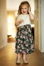 Shes an adorable little busy bee. Shot of an adorable little girl playing dress-up at home. Royalty Free Stock Photo