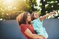 Look mommy, whats that. Shot of an adorable little girl showing her mother something in their backyard. Royalty Free Stock Photo