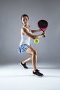 Adult fitness woman playing padel indoor. Isolated on white.