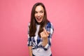 Shot of adult happy smiling beautiful brunette woman with sincere emotions wearing trendy check shirt isolated on pink Royalty Free Stock Photo