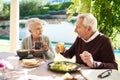 This type of love is forever. Shot of an affectionate senior couple enjoying a meal together outdoors. Royalty Free Stock Photo