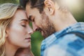 Love to your hearts content. Shot of an affectionate young couple having a romantic moment outdoors. Royalty Free Stock Photo