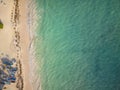 Shot from the air. Boats on the sandy beach. White sand, clean warm sea. Calm. Bright colors. There are no people in the photo.