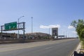 A shot along interstate 15 with cars and trucks driving on the freeway surrounded by hotels, lush green trees