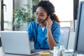 Attractive afro female doctor talking while explaining medical treatment to patient through a video call with laptop in the