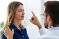 Attractive male doctor ophtalmologist checking the eye vision of beautiful young woman in modern clinic.