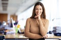 Confident businesswoman standing in a modern office and wearing casual clothes Royalty Free Stock Photo