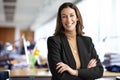 Confident businesswoman standing in a modern office and wearing business casual Royalty Free Stock Photo