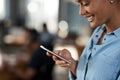 Shes got her workday all planned on her phone. Shot of an attractive young businesswoman using a cellphone in an office.