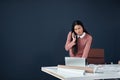 Handling business on all fronts. Shot of an attractive young female architect making a phone call while working in her Royalty Free Stock Photo