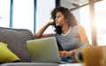 Wondering about what to research. Shot of an attractive young woman relaxing at home on the weekend. Royalty Free Stock Photo