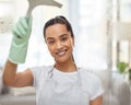 A clean house makes me happy. Shot of an attractive young woman standing alone at home and cleaning her windows. Royalty Free Stock Photo