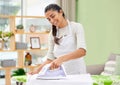 Creased clothes have never been my style. Shot of an attractive young woman standing and ironing clothes at home. Royalty Free Stock Photo