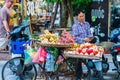 Hanoi, Vietnam - 11th October 2019: A street food seller taking fruit around on his bike for sale in the city