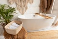 Shot of bathroom with big white bathtub and rustic decor Royalty Free Stock Photo