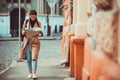 A shot of a beautiful caucasian woman traveling and reading a map to determine her next destination.