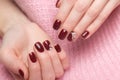 Shot beautiful manicure with flowers on female fingers. Nails design. Close-up Royalty Free Stock Photo