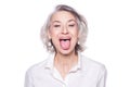 Shot of a beautiful mature woman having fun and teasing sticking out her tongue isolated on white background Royalty Free Stock Photo