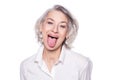 Shot of a beautiful mature woman having fun and teasing sticking out her tongue isolated on white background Royalty Free Stock Photo