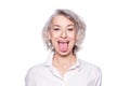 Shot of a beautiful mature woman having fun and teasing sticking out her tongue isolated on white background Royalty Free Stock Photo