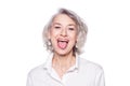 Shot of a beautiful mature woman having fun and teasing sticking out her tongue isolated on white background Royalty Free Stock Photo