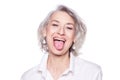Shot of a beautiful mature woman having fun and teasing sticking out her tongue isolated on white background Royalty Free Stock Photo