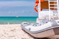 Shot of the beautiful tropical beach in a sunny day of summer, with a lifeguard place and boat parked on the seaside