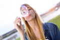 Beautiful young woman having fun with soap bubbles in the park. Royalty Free Stock Photo