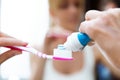 Beautiful young woman holding her tooth-brush with toothpaste at home. Royalty Free Stock Photo